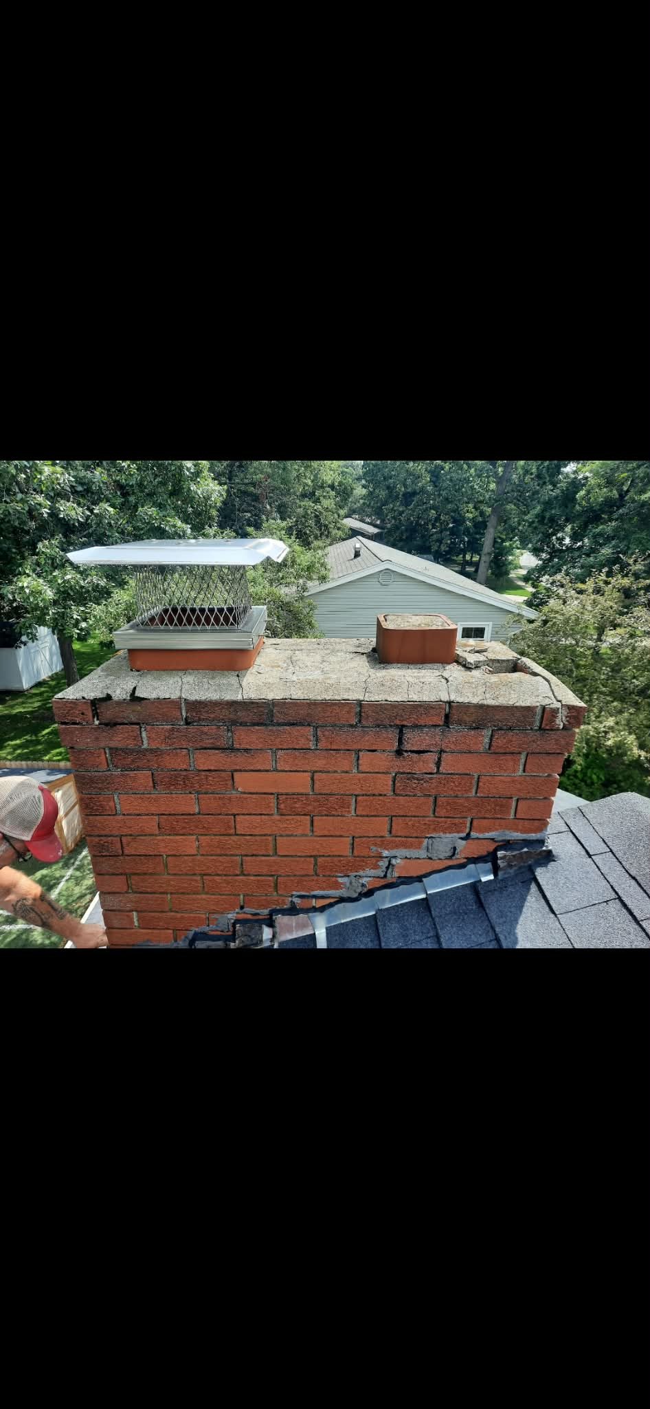 Damaged twin flue brick chimney with cracked mortar and step cracking